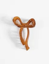 Broche para el pelo color marrón con forma de moño rígido.