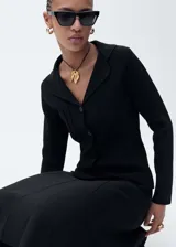Chaqueta de punto negra con cuello de solapa, cierre frontal de botones y diseño entallado de manga larga.