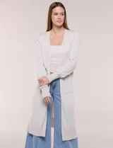 Cardigan largo de punto liviano y suave, de color blanco, con diseño abierto al frente, mangas largas con puños acanalados y bolsillos frontales aplicados.