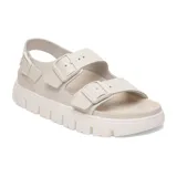 Sandalias planas color hueso con dos correas anchas ajustables con hebillas y correa trasera.