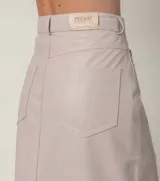 Pollera midi de cuero ovino con diseño tipo jean, cierre frontal con botón y tajo central.