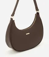 Cartera tipo baguette color marrón de poliuretano, con cierre de cremallera superior, asa ajustable y herrajes metálicos dorados.
