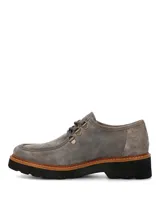Zapato acordonado Hush Puppies modelo Renovo, confeccionado en descarne color gris. Presenta un diseño robusto con suela gruesa de EVA, costuras visibles en el borde y ojales metálicos para los cordones.