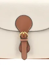 Cartera bandolera de cuero graneado en color off-white con detalles en marrón tostado, solapa frontal con cierre de hebilla metálica dorada y broche a presión.
