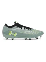 Championes de fútbol Under Armour Magnetico Select 4 FG, color verde grisáceo con detalles en amarillo neón y negro. Presentan una parte superior de piel sintética con estampado 3D para mayor control, cuello textil tipo calcetín y suela de TPU con tacos cónicos para tracción en césped natural.