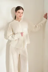 Camisa de lino italiano color beige, de corte holgado, con cuello mao, manga larga y bolsillo aplicado en el pecho.