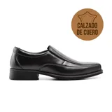 Zapato de vestir de cuero negro, sin cordones, con puntera cuadrada y suela de goma.