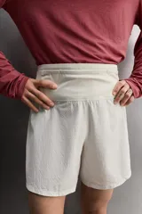 Short deportivo de trail running confeccionado en tejido técnico elástico con textura. Presenta una cintura elástica ancha con compartimentos integrados, bolsillo trasero con cierre y aberturas laterales en el bajo.