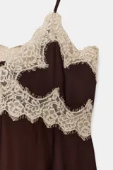 Top de tirantes finos color marrón oscuro con escote en pico y detalles de encaje beige en el busto y el ruedo inferior.