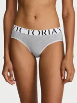 Bombacha hiphugger de Victoria's Secret en color gris melange, confeccionada en mezcla de algodón, con cintura elástica ancha en color blanco y el nombre de la marca en letras negras.