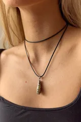 Collar con dije de piedra natural en forma de gota con jaspe dálmata, con argolla de acero quirúrgico y tira de tiento negro.