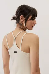 Vestido largo color verde suave, sin mangas, con escote redondo y silueta al cuerpo que se ensancha levemente hacia el dobladillo.