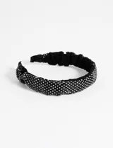 Vincha ancha de color negro recubierta con pequeños cristales de strass brillantes sobre una base de plástico.