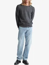 Sweater gris de punto liso, con cuello redondo y mangas largas. Tiene el logo de Calvin Klein bordado en el pecho.