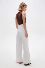 Pantalón de jean blanco de tiro alto, corte ancho y recto, con bolsillos laterales.