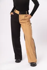 Pantalón fluido de tiro alto con bolsillos delanteros y traseros. Cierre frontal con cremallera y botón. Diseño color block negro y beige.