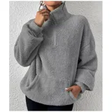 Buzo de polar con textura suave, color beige, con cuello alto y cierre frontal parcial. Diseño de manga larga y calce holgado.