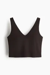 Cropped top deportivo color marrón, con escote en V, tirantes anchos y diseño ajustado, confeccionado en tejido funcional con tecnología SoftMove y DryMove.