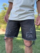 Bermuda de jean celeste con roturas y detalles deshilachados en el ruedo.