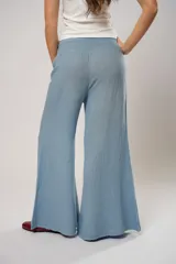 Pantalón celeste de corte palazzo, con cintura elastizada y tiro alto.