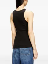Musculosa blanca de canalé con escote redondo y tirantes anchos, confeccionada en algodón y elastano. Presenta un pequeño detalle metálico con el logo en el centro del pecho.