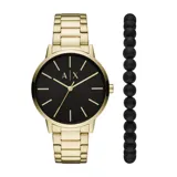 Reloj de pulsera con caja y malla de acero inoxidable en tono dorado, esfera negra minimalista con índices y manecillas doradas. Incluye una pulsera de cuentas negras mate.