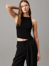 Top sin mangas negro de punto de rayón suave con sutil efecto brillante y bajo asimétrico. Diseño con espalda cruzada y bordado de Calvin Klein en la misma gama de tonos en el bajo.