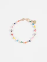 Pulsera dorada con cadena de eslabones y dijes de ojitos turcos de colores.