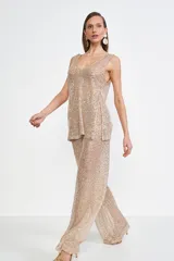 Pantalón dorado de lentejuelas, corte palazzo y cintura alta.