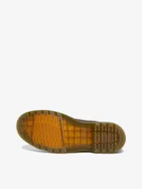 Bota Chelsea Dr. Martens 2976 YS Crazy Horse, color marrón, fabricada con cuero Crazy Horse desgastado. Presenta paneles elásticos laterales, costuras amarillas Goodyear y una tira de tela amarilla con el logo de la marca en la parte trasera.