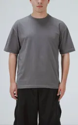 Remera de algodón premium color gris concreto, con corte crop, calce oversize, hombros caídos y cuello redondo rib al tono.