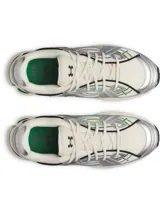 Championes deportivos de diseño retro-futurista, con base de malla color crema y superposiciones de cuero sintético metalizado plateado. Presenta detalles lineales en color verde y una entresuela robusta de EVA en tono crema con acentos verdes en el talón.