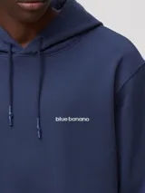 Hoodie azul marino de algodón orgánico con capucha, corte regular fit y un gran estampado en la espalda en forma de 'X' con bordes claros.