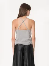 Top negro de punto con strass, escote halter con cuello a la base y breteles finitos cruzados en la espalda.