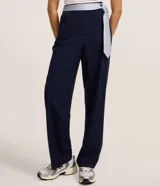 Pantalón de sastrería corte recto color gris, con bolsillos laterales tipo cuchillo y trabillas para cinturón.