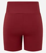Bermuda deportiva femenina color bordó, tiro alto, confeccionada en microfibra. Presenta un recorte lateral contrastante de color rosado claro que recorre la pierna.