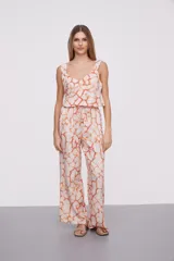 Pantalón largo de viscosa con estampado abstracto en tonos azules y blancos, cintura alta con cordón ajustable y corte ancho.