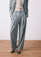 Pantalón de vestir celeste de corte recto y holgado, con pinzas en la parte delantera y bolsillos laterales.