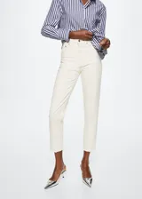 Jeans de tiro alto con corte mom-fit, confeccionados en tejido de algodón estilo vaquero. Presentan diseño de cinco bolsillos, trabillas para cinturón y cierre frontal con cremallera y botón.