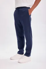 Pantalón deportivo de corte recto en color azul marino, con cintura elástica y cordón ajustable. Cuenta con bolsillos laterales.