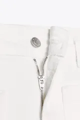 Pantalón de jean blanco de tiro alto y corte wide leg, con bolsillos delanteros y traseros. Cierre frontal con cremallera y botón metálico.