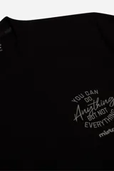Remera manga larga de textura marcada, color negro, con estampa tipográfica pequeña en el pecho. Presenta un corte regular y cuello redondo.