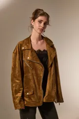 Chaqueta tipo biker de gamuza sintética color tostado, con cuello solapa, cierre frontal y diseño holgado.