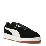 Championes urbanos Puma modelo Shuffle Downtown Sd, color negro con detalles en blanco y suela de goma color caramelo. Presentan el logo de la marca en dorado en el lateral y diseño clásico de corte bajo.