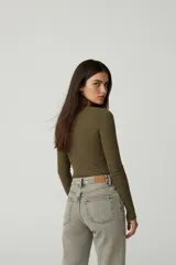 Remera de manga larga confeccionada en tejido de punto canalé, con ajuste al cuerpo y cuello redondo.