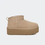 Botas de caña baja UGG modelo Ultra Mini Platform, confeccionadas en gamuza color tostado con plataforma elevada y forro interior de lana.