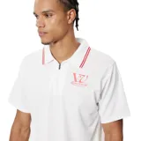 Chomba blanca con cuello tipo polo con cierre de cremallera corto y ribete rojo. Tiene un logo estampado en el pecho.