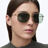 Lentes de sol con montura metálica dorada de diseño geométrico inspirado en el estilo aviador, con lentes polarizadas en color verde oliva.