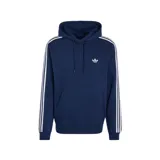 Canguro Adidas de color azul marino con capucha ajustable con cordón, bolsillo tipo canguro al frente, las clásicas tres tiras blancas en las mangas y el logotipo del Trifolio bordado en el pecho.