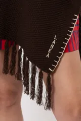 Ruana marrón chocolate tejida, con detalles bordados a mano en los bordes y flecos en el ruedo inferior.